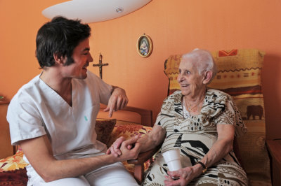 Caregiver and an elder woman is having a happy conversation